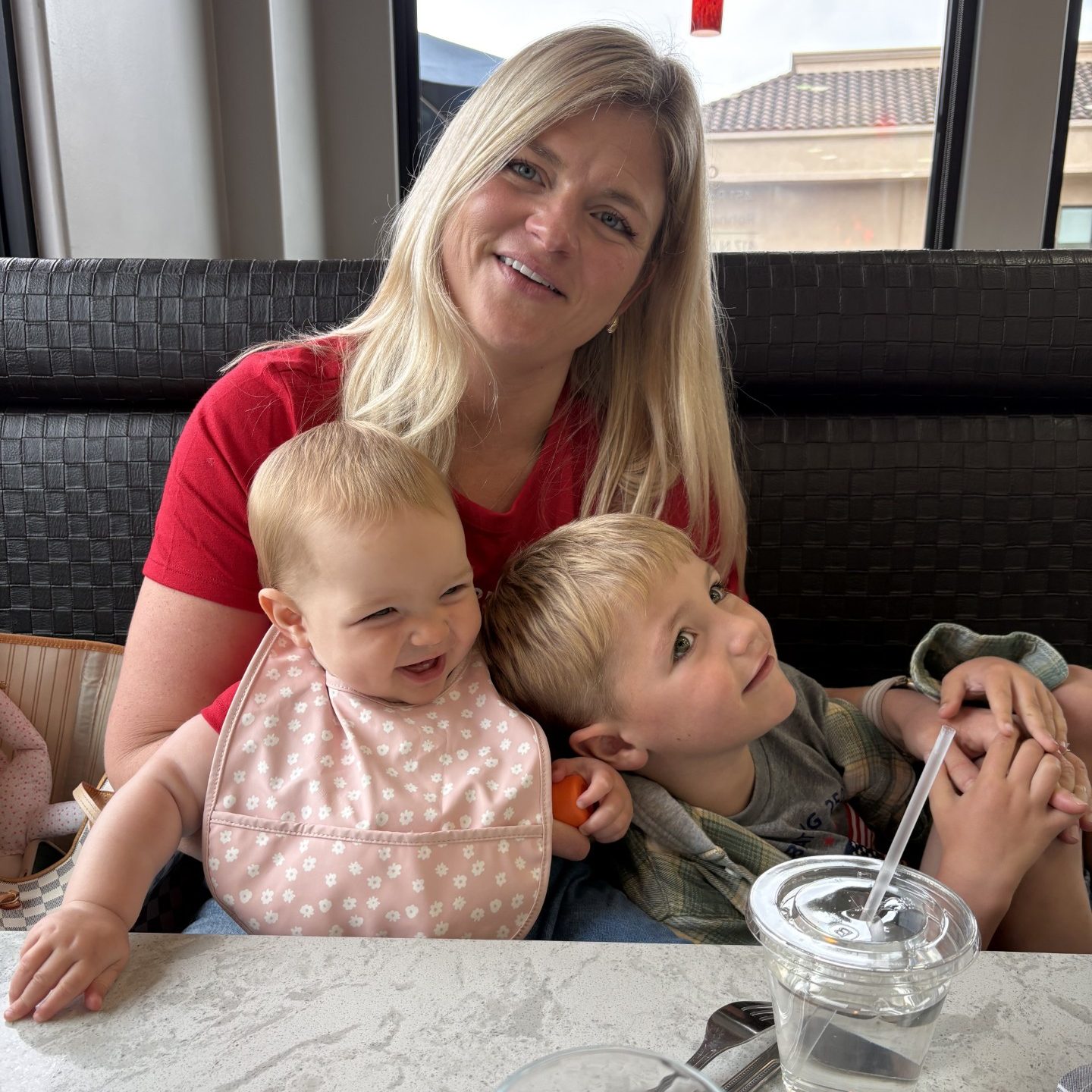 Rachel D. at a restaurant table with her son Harvey and daughter Penny