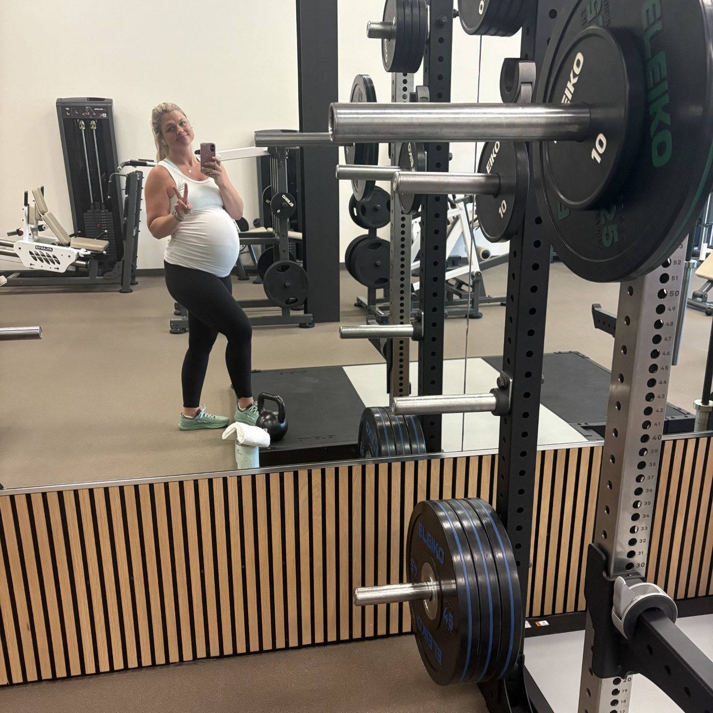 Rachel D. taking a mirror selfie at somofit while pregnant with Penny